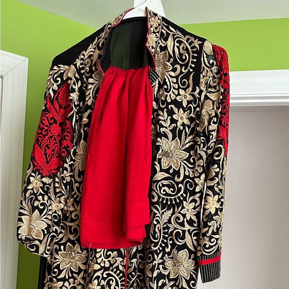 Indian salwar kurta. The salwar is red and skirts has embroidery work.